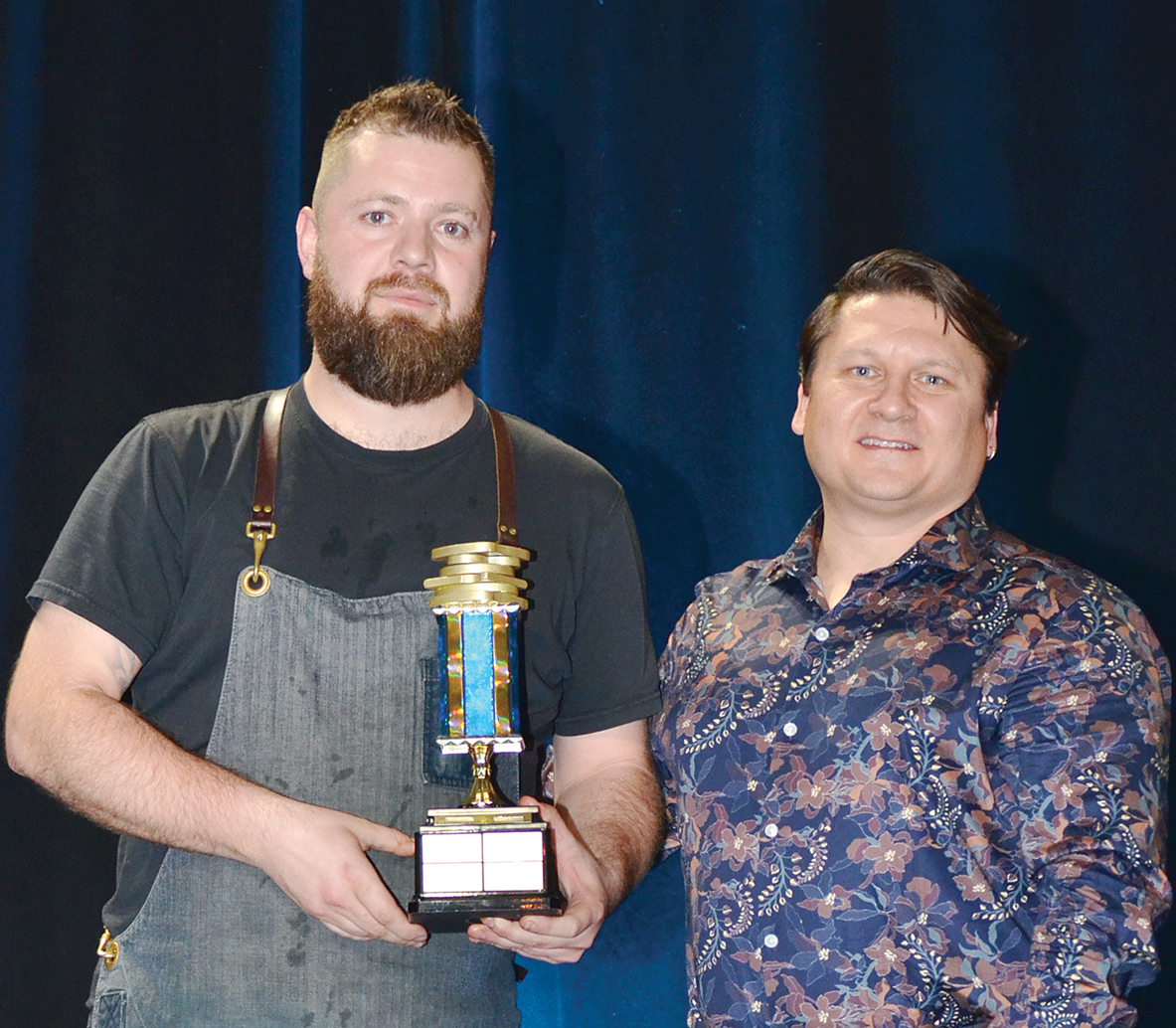 Justin Champagne receives the trophy for best sandwich from Jeff Bond at this year’s Hopewell Eating Disorder Centre’s Breaking Bread Breaking Stigma competition.