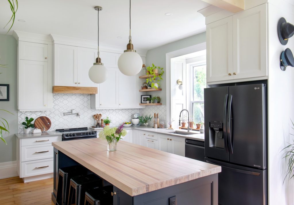 A kitchen with white cupboards. 