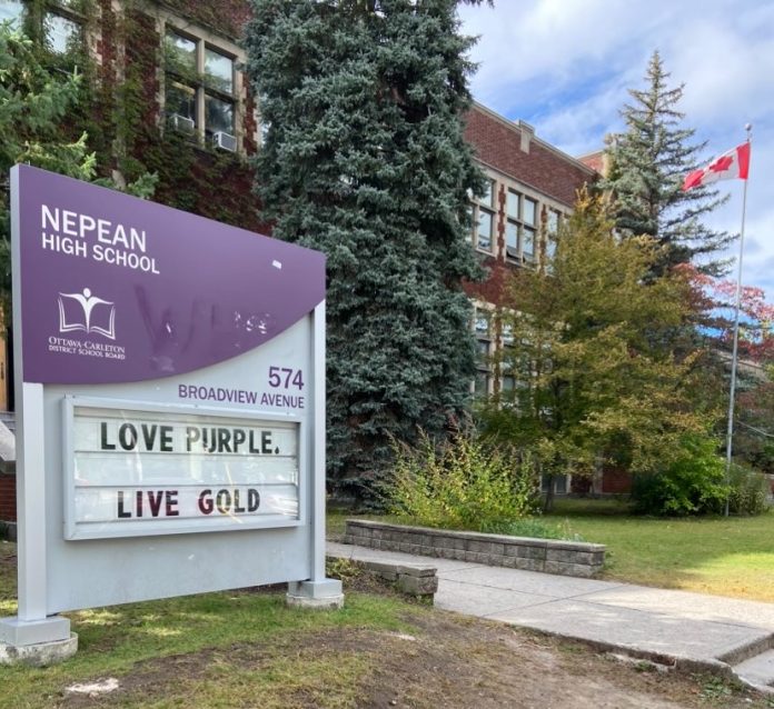 A purple and white sign outside on the lawn on Nepean High School. The sign reads 