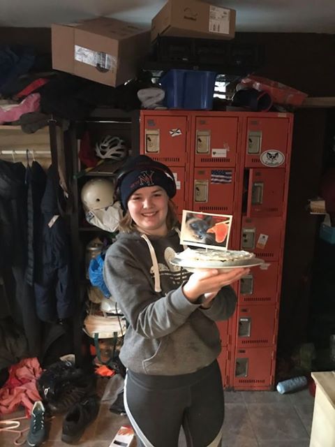 A photo of Isabelle Golding holding a cake in Hintonburg this spring. 