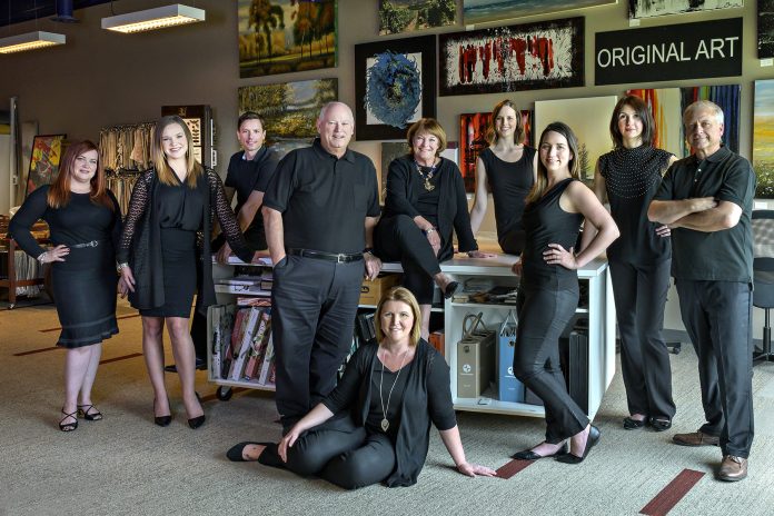 A group photo of the team at CPI Interiors inside an office space.|A group photo of the team at CPI Interiors inside an office space.