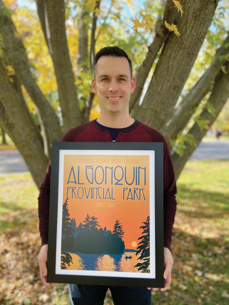 Michael Moir holding a colourful print from his company Damn Fine Prints Canada.