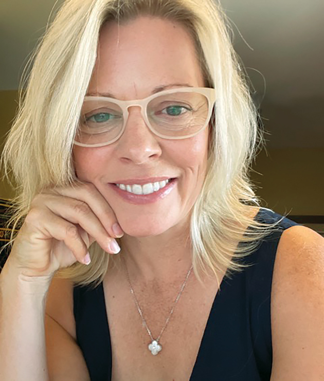 A blonde woman wearing glasses is seen in a self-taken photo.