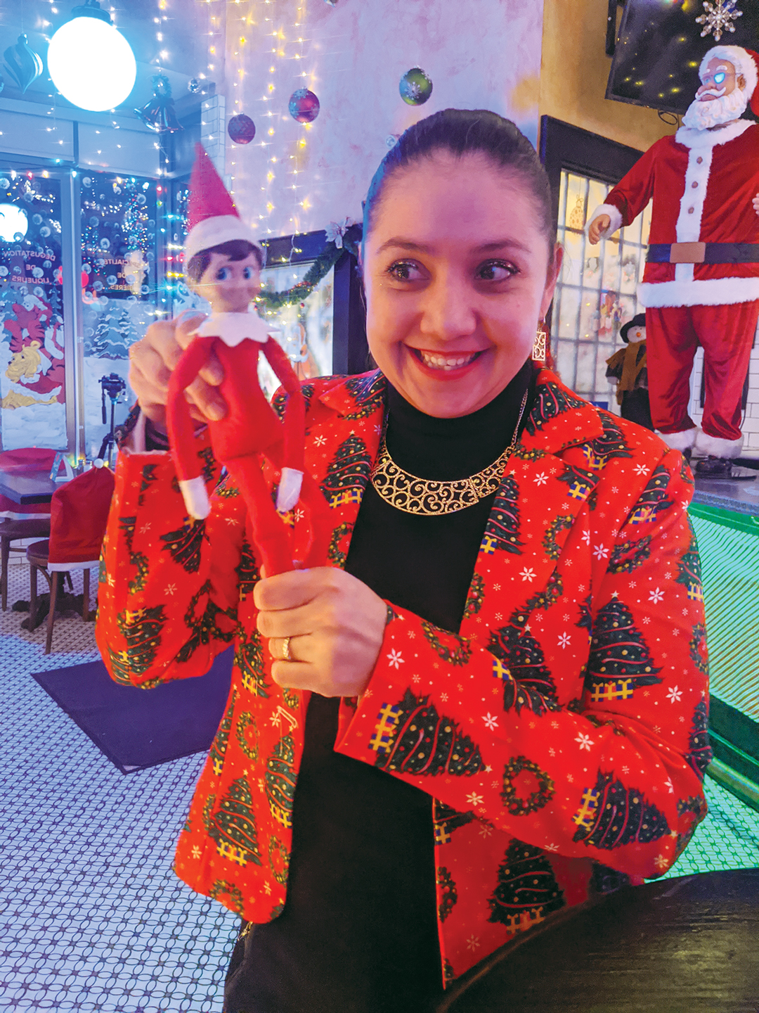 Miriam Lautru, the operations manager at the Savoy holds up an elf surrounded by Christimas decorationsready for Miracle Pop-up at the Savoy