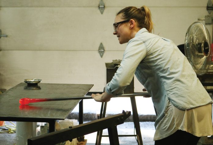 An expert glassblower demonstrates her craft during the Ottawa Glassblowing Cooperative’s grand opening in November.|Expert glassblower put on a demonstration of their work for a crowd during the Ottawa Glassblowing Cooperative’s grand opening in November.