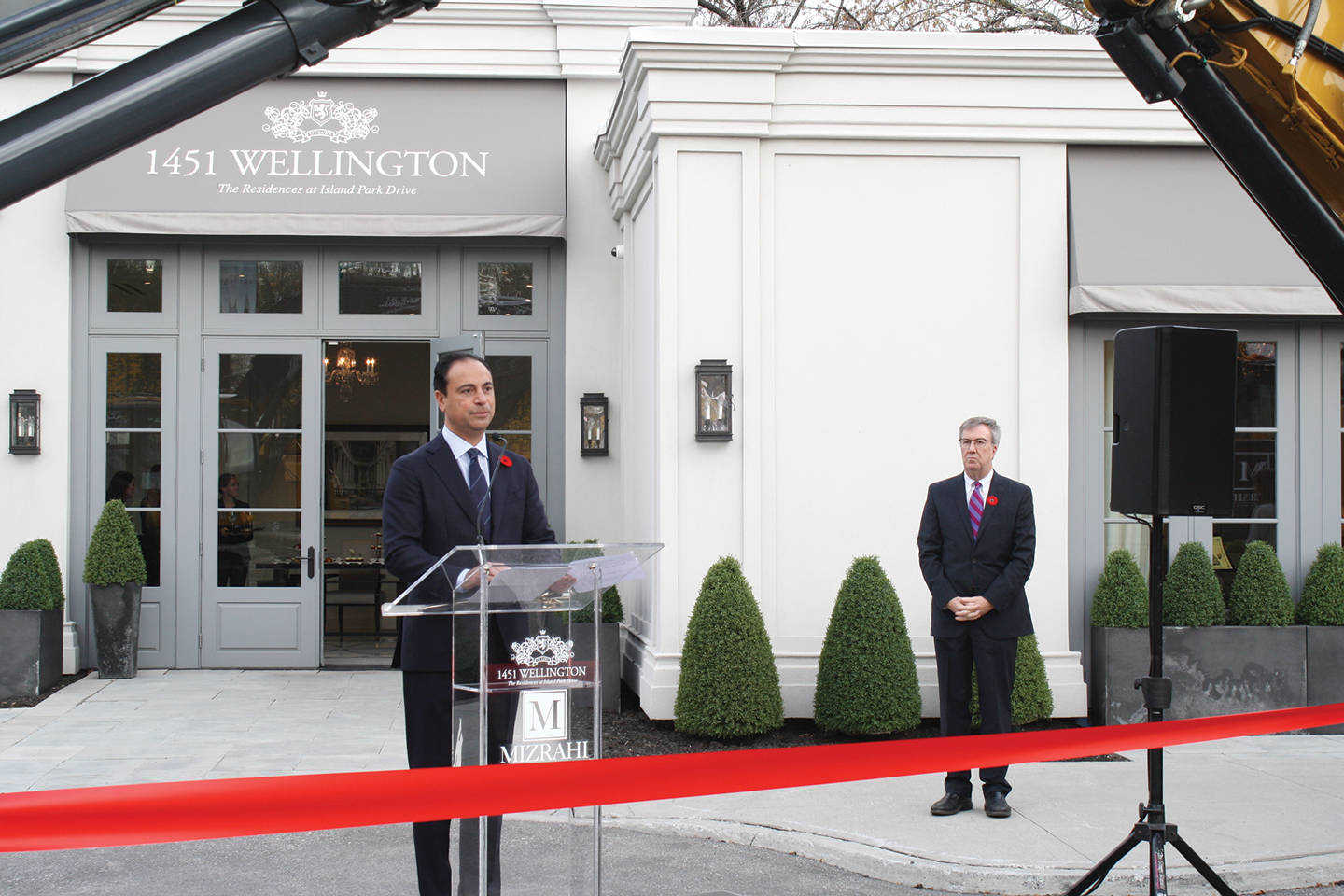 Sam Mizrahi, owner of Mizrahi Developments, with Ottawa Mayor Jim Watson in the background, speaks at the groundbreaking ceremony for a new 12-storey building on Wellington. 