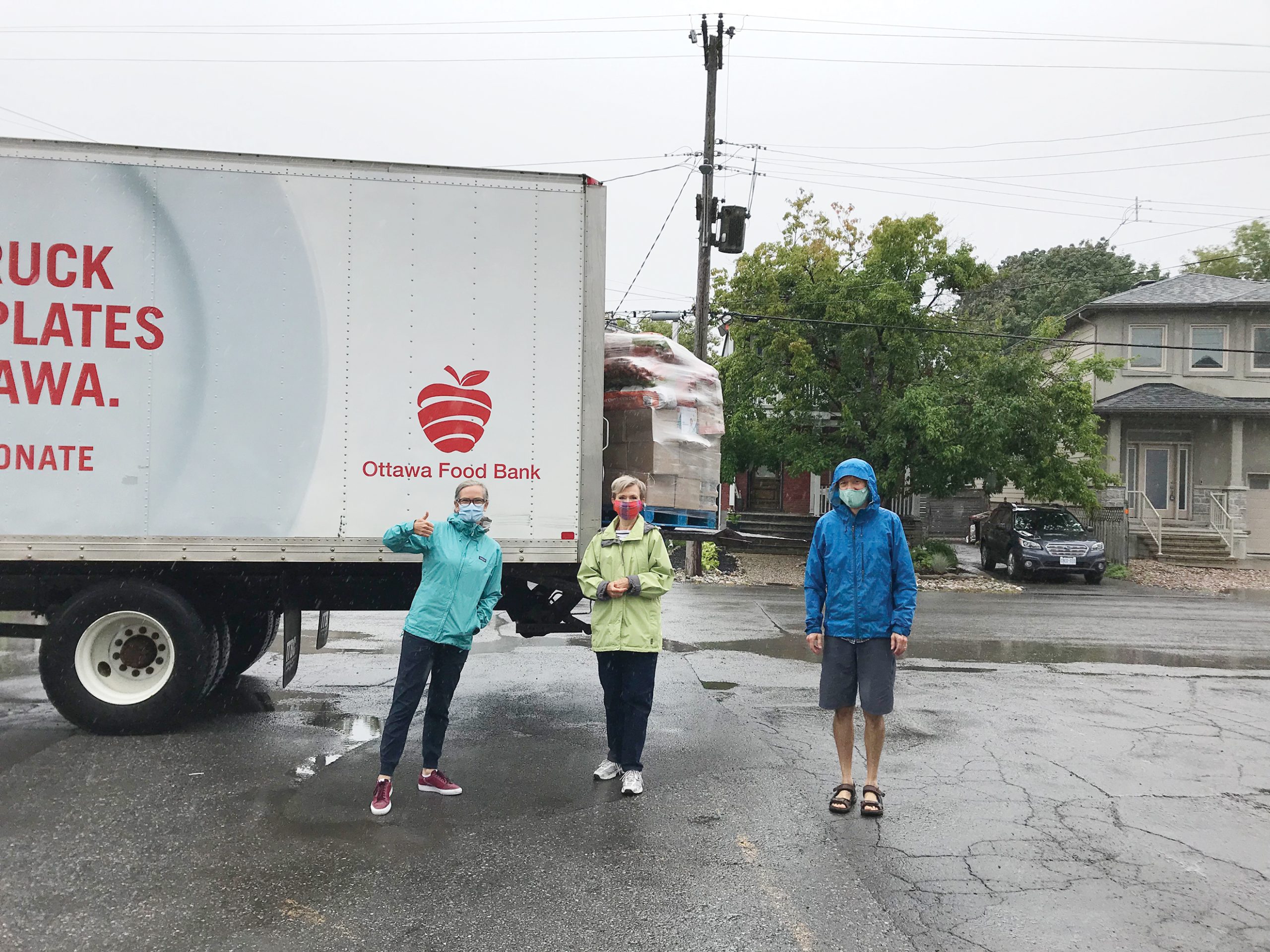 A photo of the food bank volunteers outside in Westboro in front of a food delivery truck,