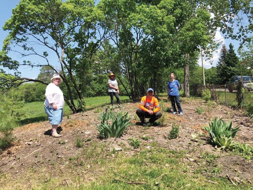 A photo of the Westboro Beach Community Association at the pollinator garden. 