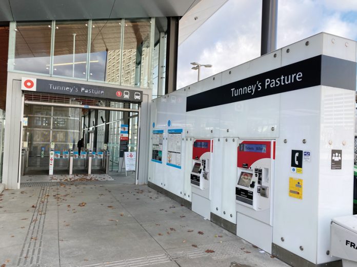 An empty entrance to the Tunney's Pasture LRT train station on a sunny day in November.|