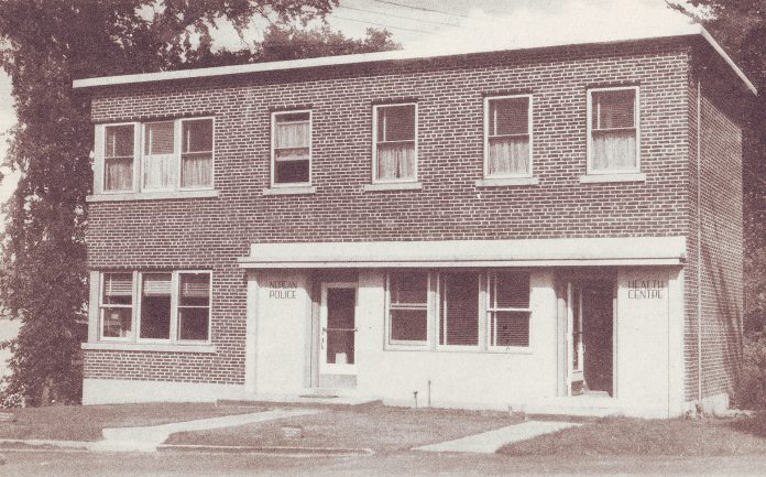 A photo of the Nepean Police station on a sepia postcard from 1947.|A black and white group photo of the Nepean police taken outside the station in 1947.|A photo of an Ottawa Citizen article from 1945 advertising the station and health centre.|A photo of four Nepean Police Force members outside the station in 1947.||