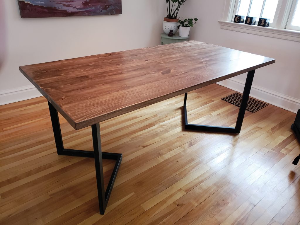 A photo of a pine table with Chevron style legs made by Maker House.