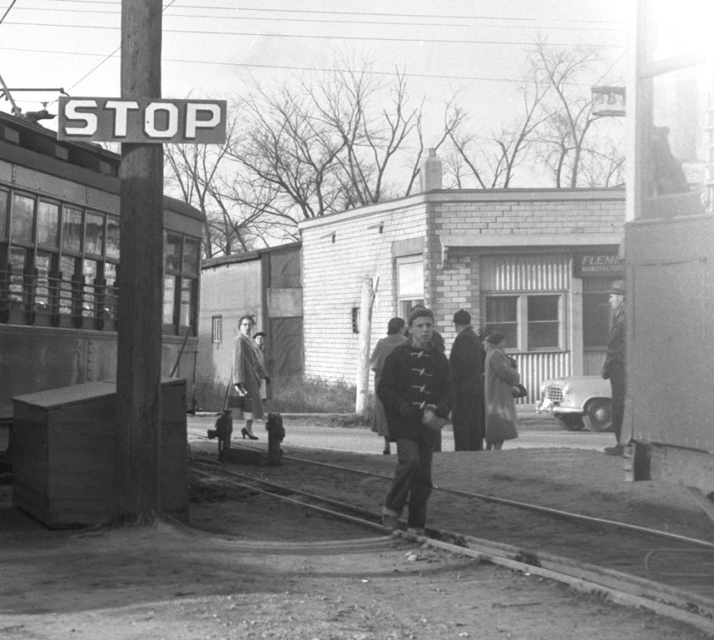 A black and white photo from the mid-1950s shows Laundry Land as a white brick building with pedestrians out front