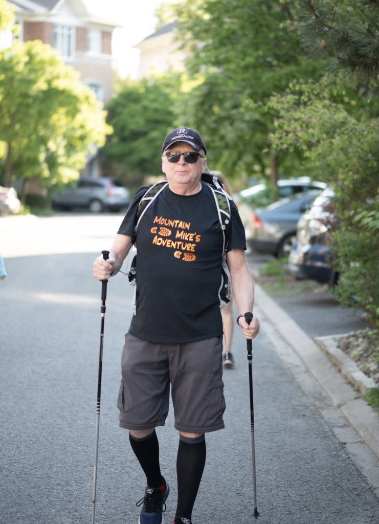 Michael Baine is seen walking outside with walking sticks