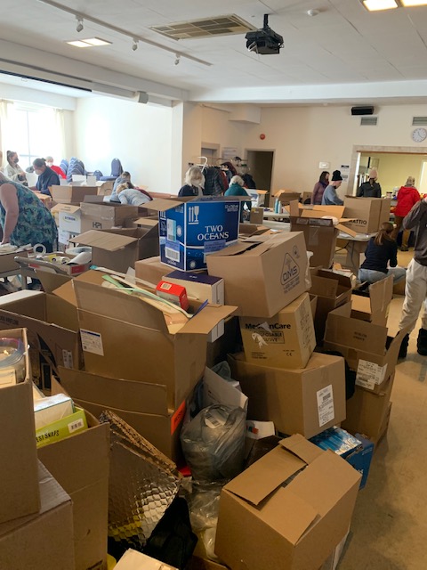 A stack of cardboard boxed full of donations at the Ukranian church on Byron Avenue.|A pile of toys in bags for donation|||