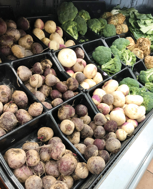 A row of vegetables is seen in a grocery store.