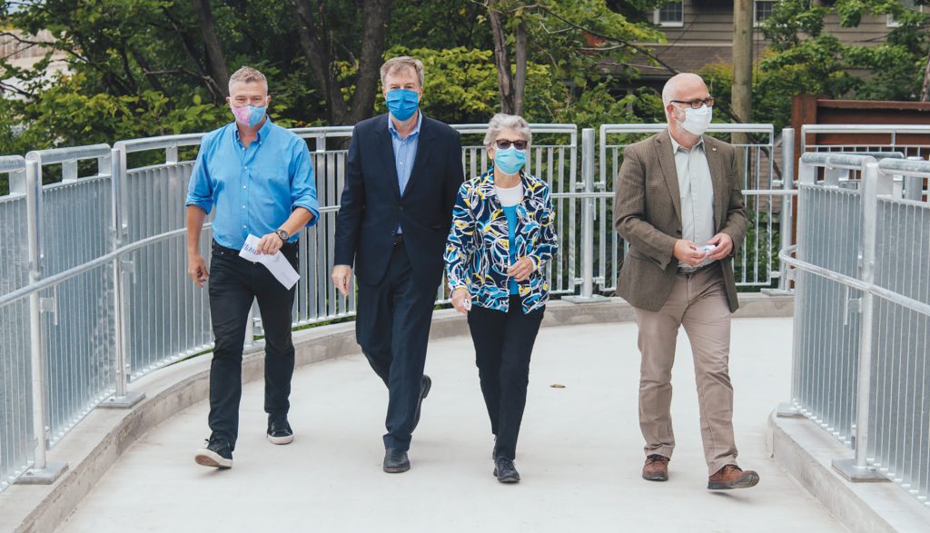 Councillors, the mayor and former mayor take a walk on the Jackie Holzman Bridge.