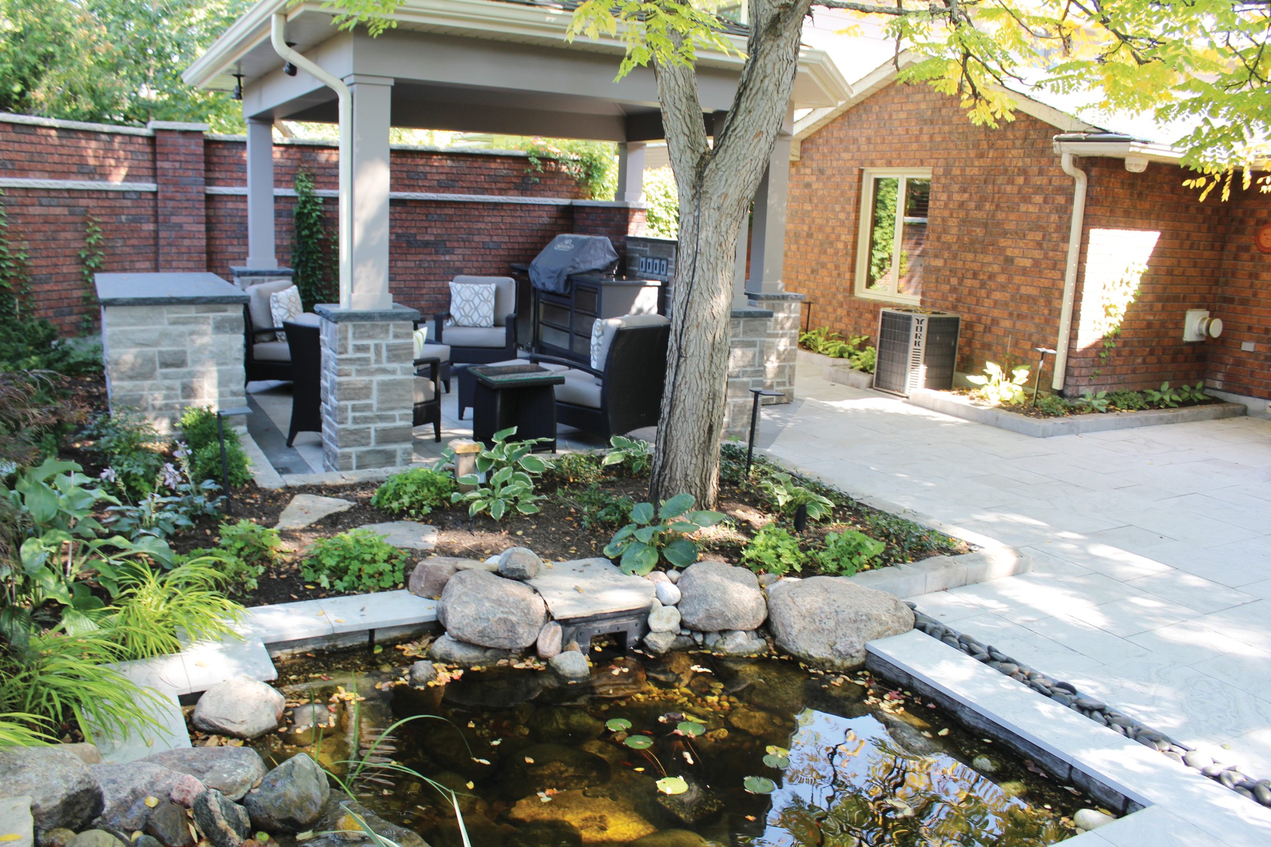 A photo of a yard space with a dining area and water features.