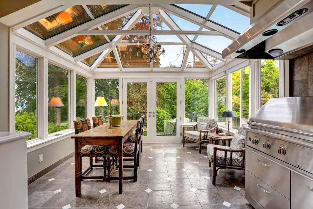 A photo of an indoor outdoor space with glass all around.