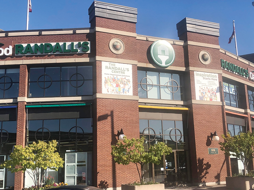 The outside of the brick building where Randall's Paint works from on Bank Street on a sunny day in Ottawa