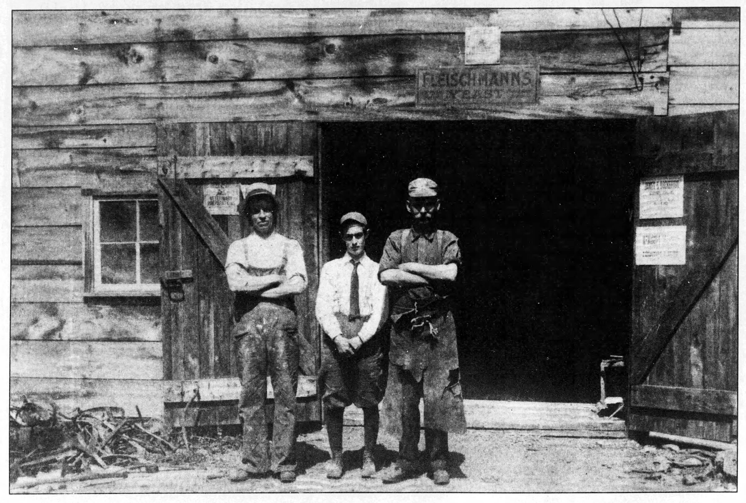 An old photo from 1914, showing Patrick Mears, his son Wilfred and William Pack in front of a blacksmith shop.