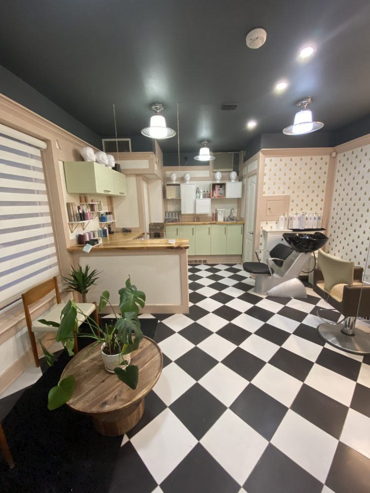 The inside of ApartMint Hair Studio in Hintonburg with a black and white checkered floor and white walls