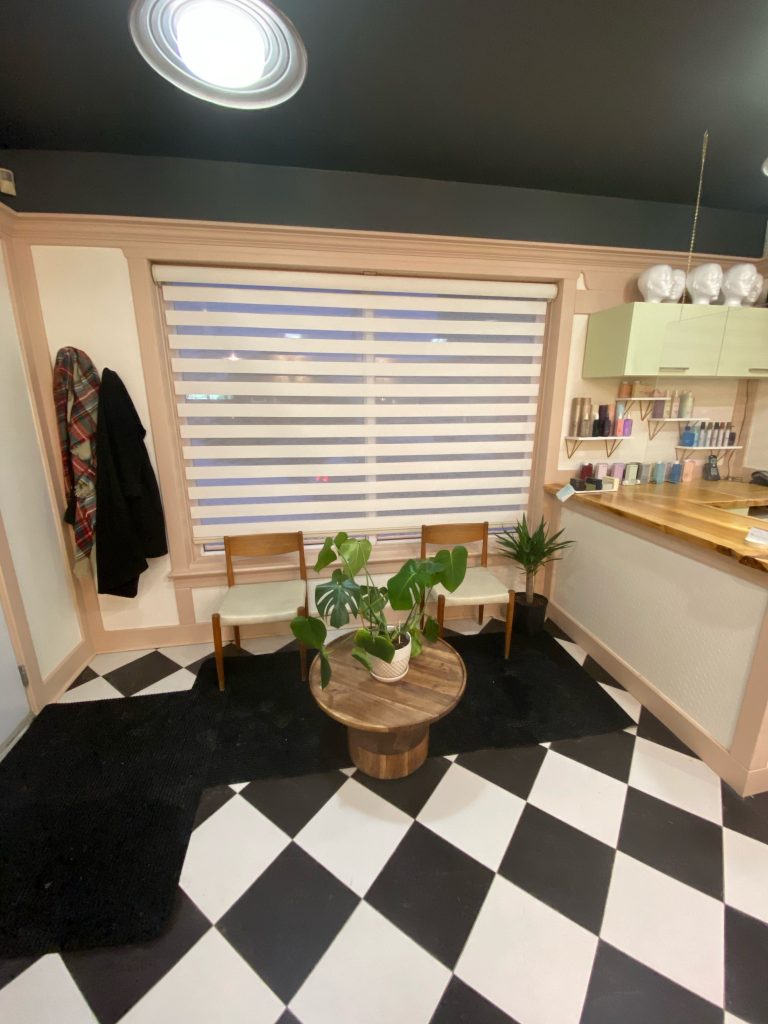 The inside of ApartMint Hair Studio in Hintonburg with a black and white checkered floor and white walls