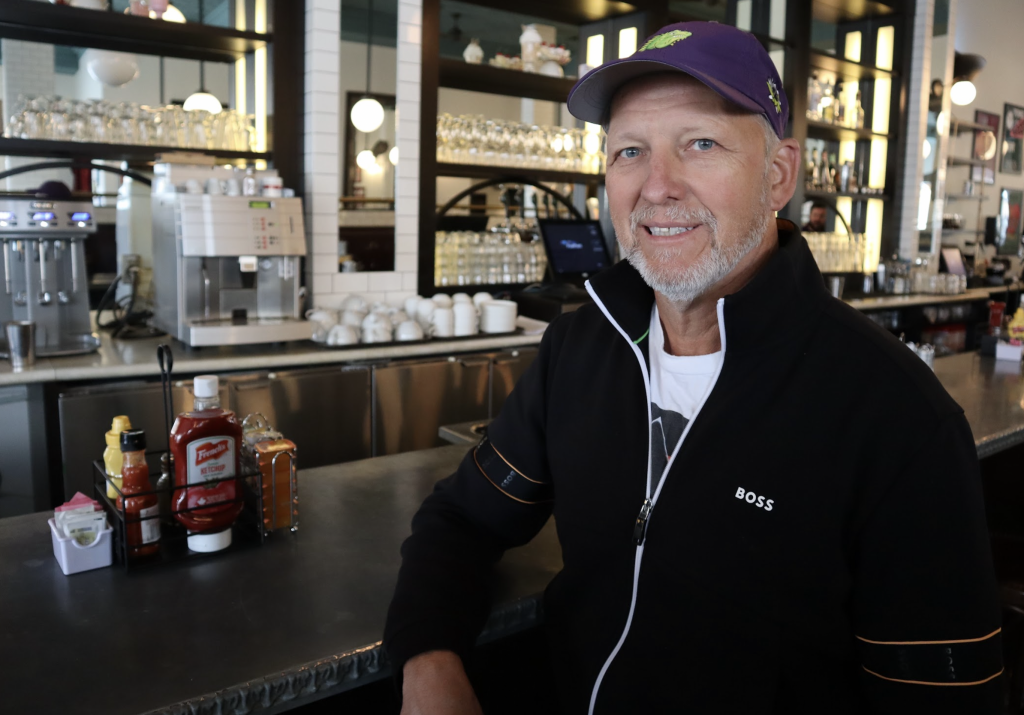 John Borsten poses for a photograph at the bar inside Westboro’s Zak’s Diner.