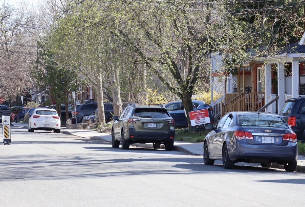 Three cars parked on a side street. 