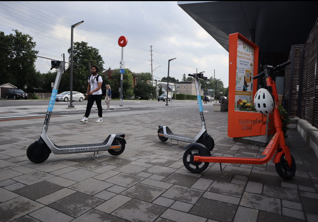 Scooters are parked outside of Tunney’s Pasture. 