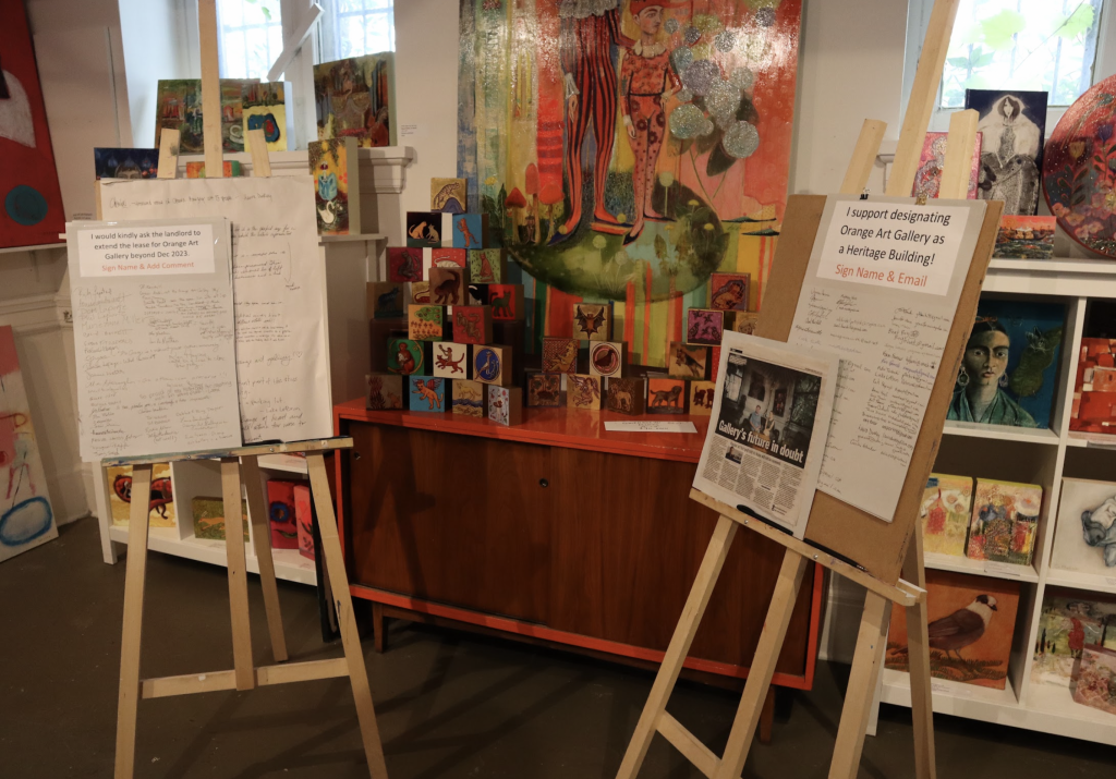 Two petitions are on display on easels in the art gallery.