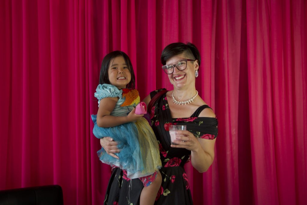 A woman and her young daughter pose for a photo.