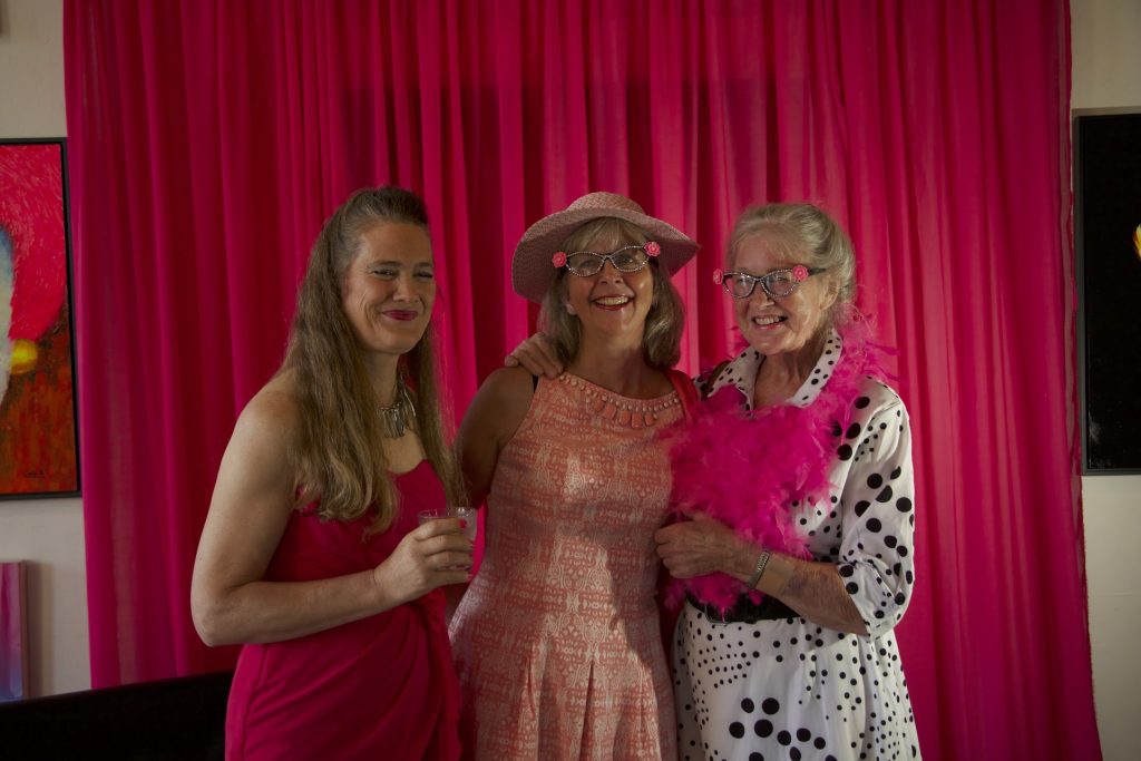 Three women pose for a photo.