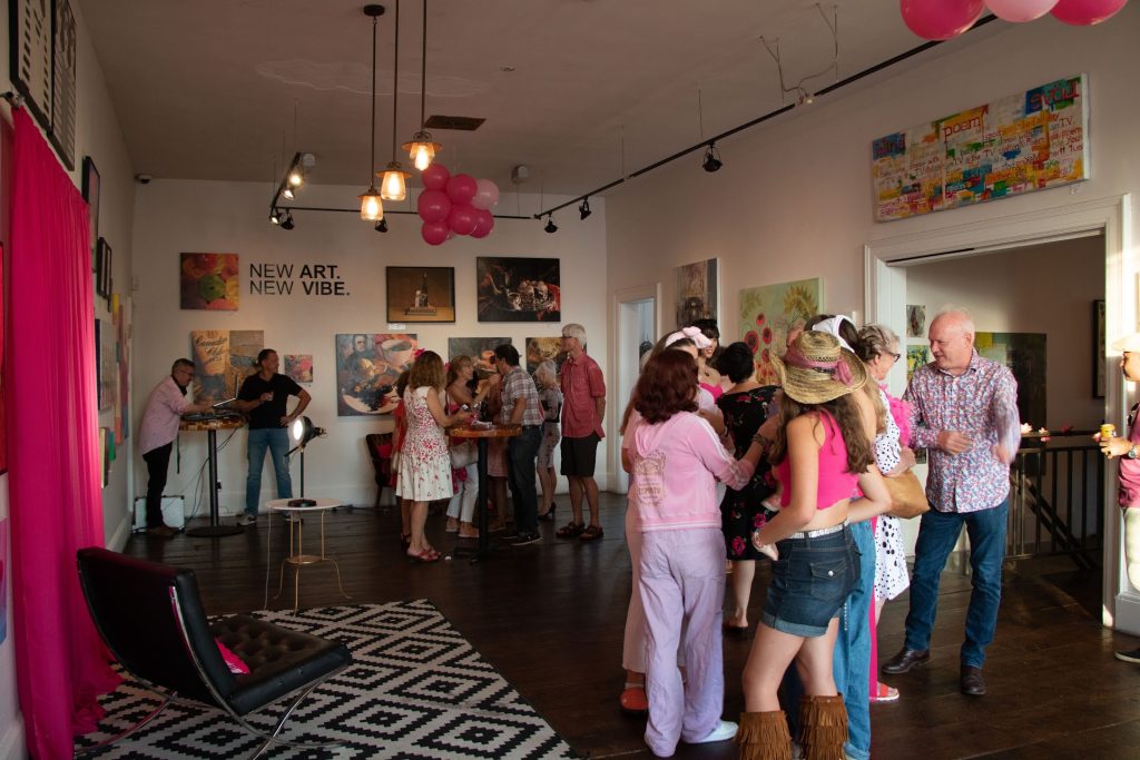 Many guests socialize in the Orange Art Gallery’s main room. 