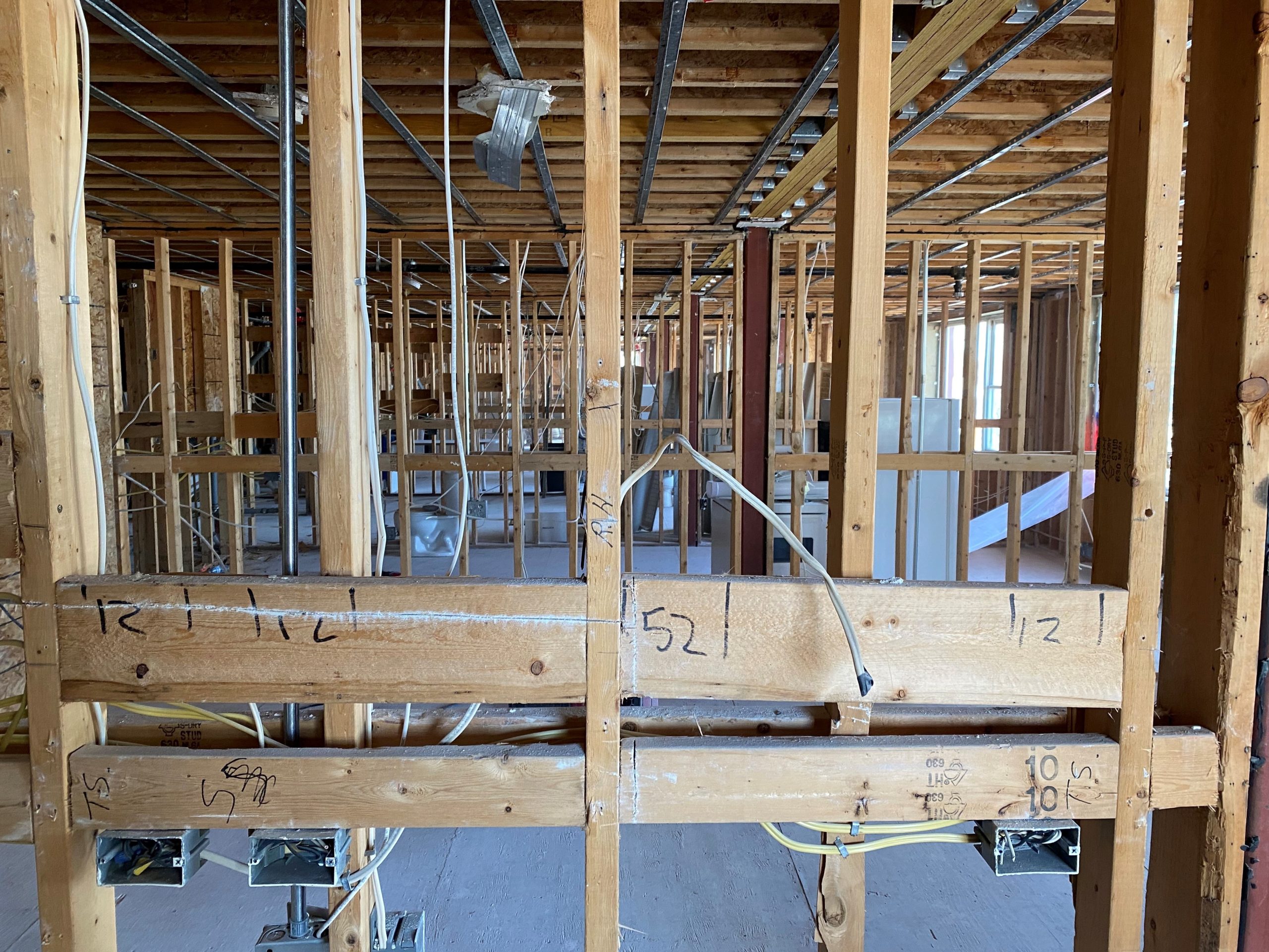 A photo showing all the wooden beams after all the drywall, flooring, and ceilings were removed.