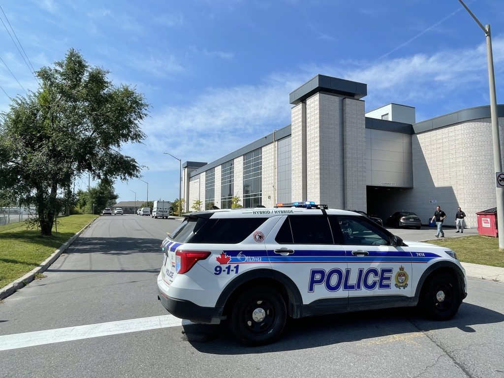 A police cruiser outside of a convention centre. 