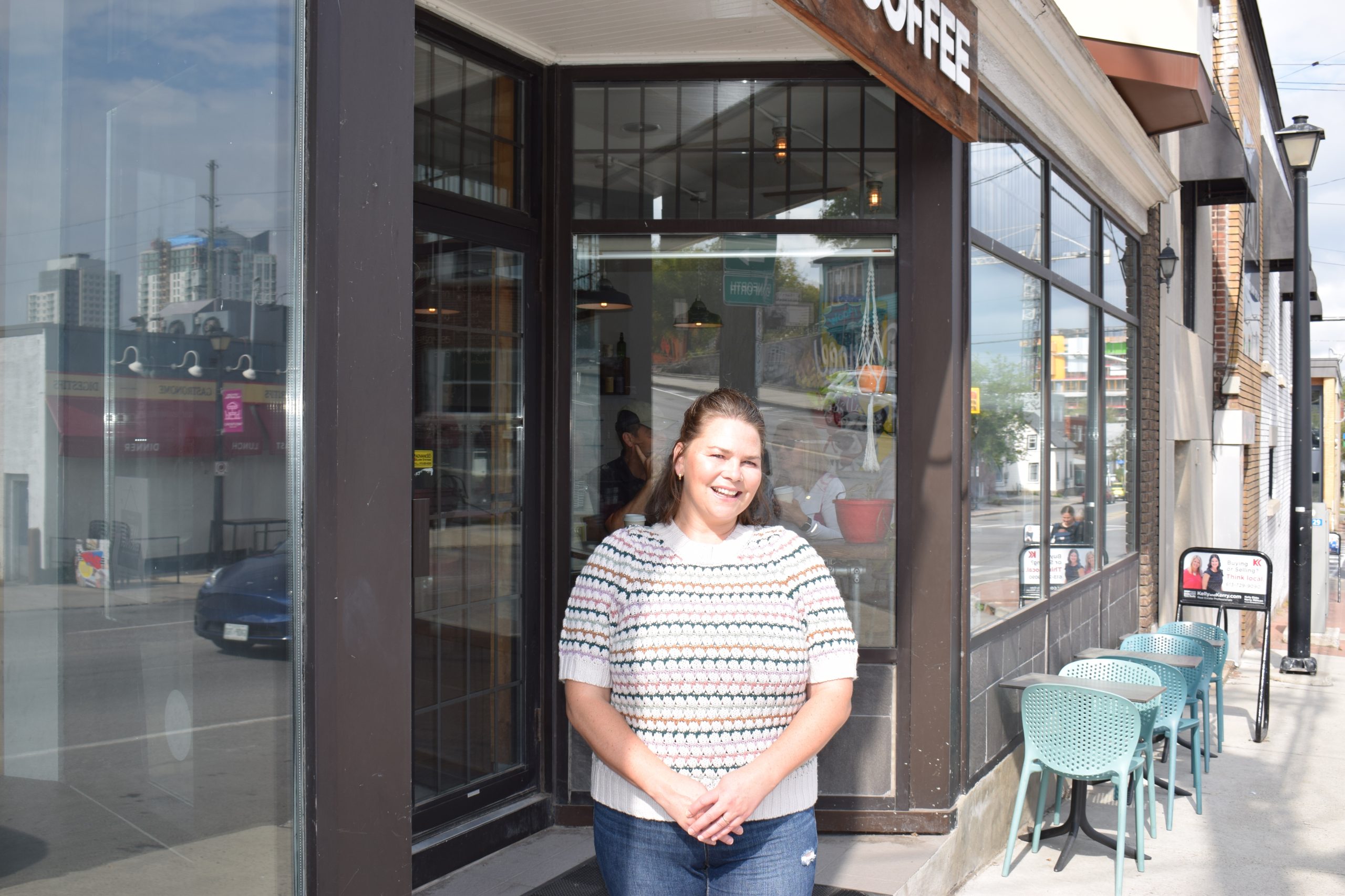 Sarah poses for a photograph outside Equator Coffee in Westboro. 