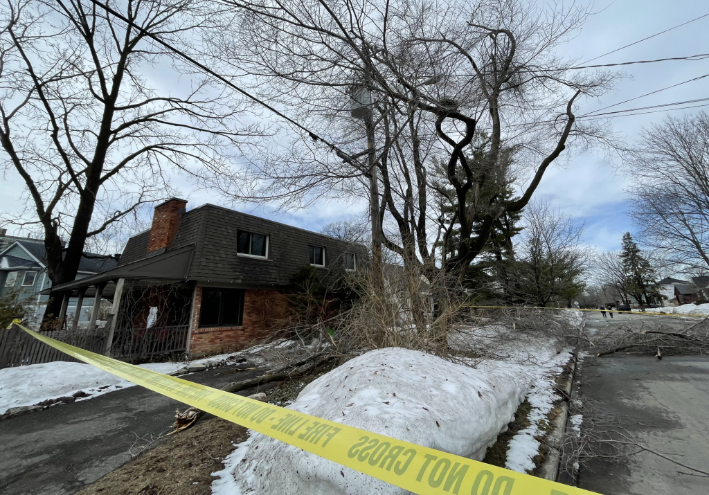 Caution tape closes down a road where fallen branches took down part of a hydro line.