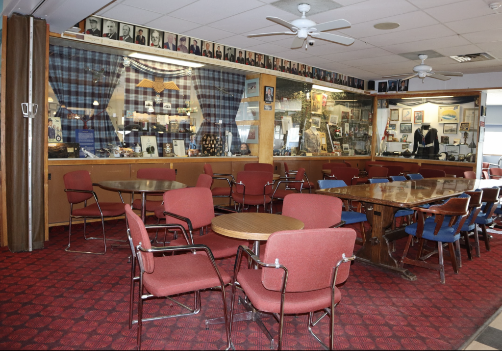 A seating area inside the legion. Display cases with memorabilia are in the background.