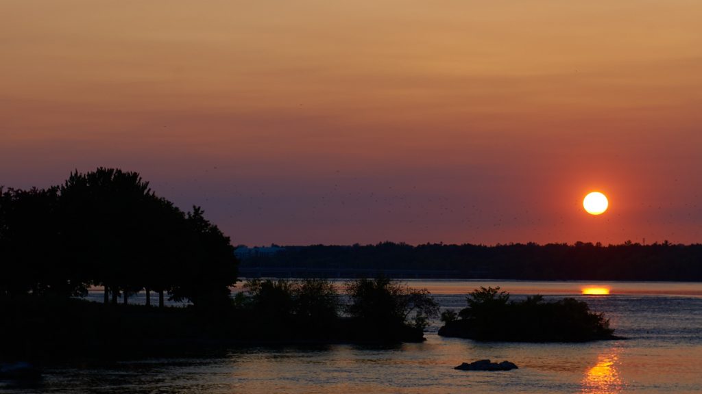 An orange sunset over the river. 