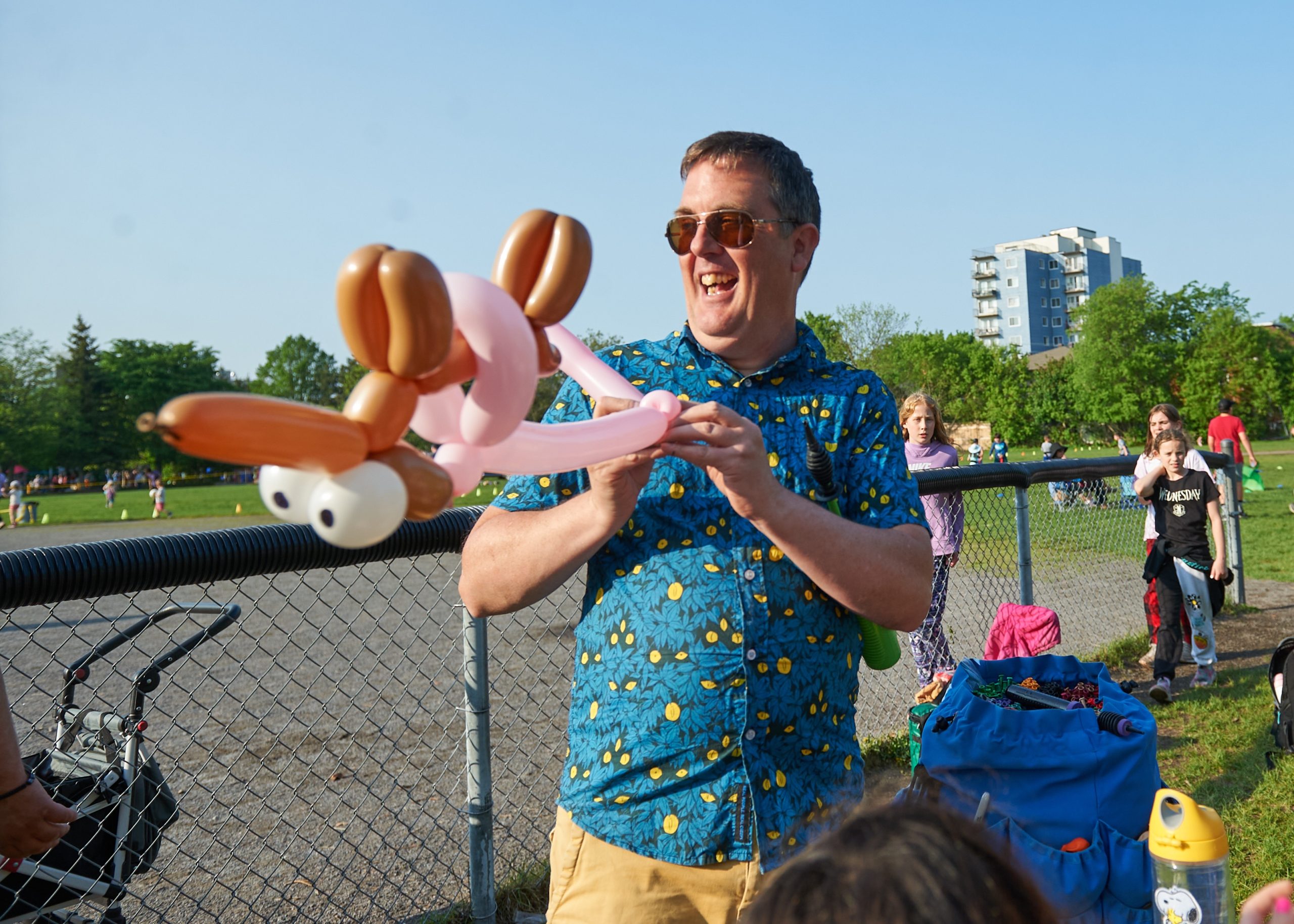 Brad smiles as he makes a balloon animal.