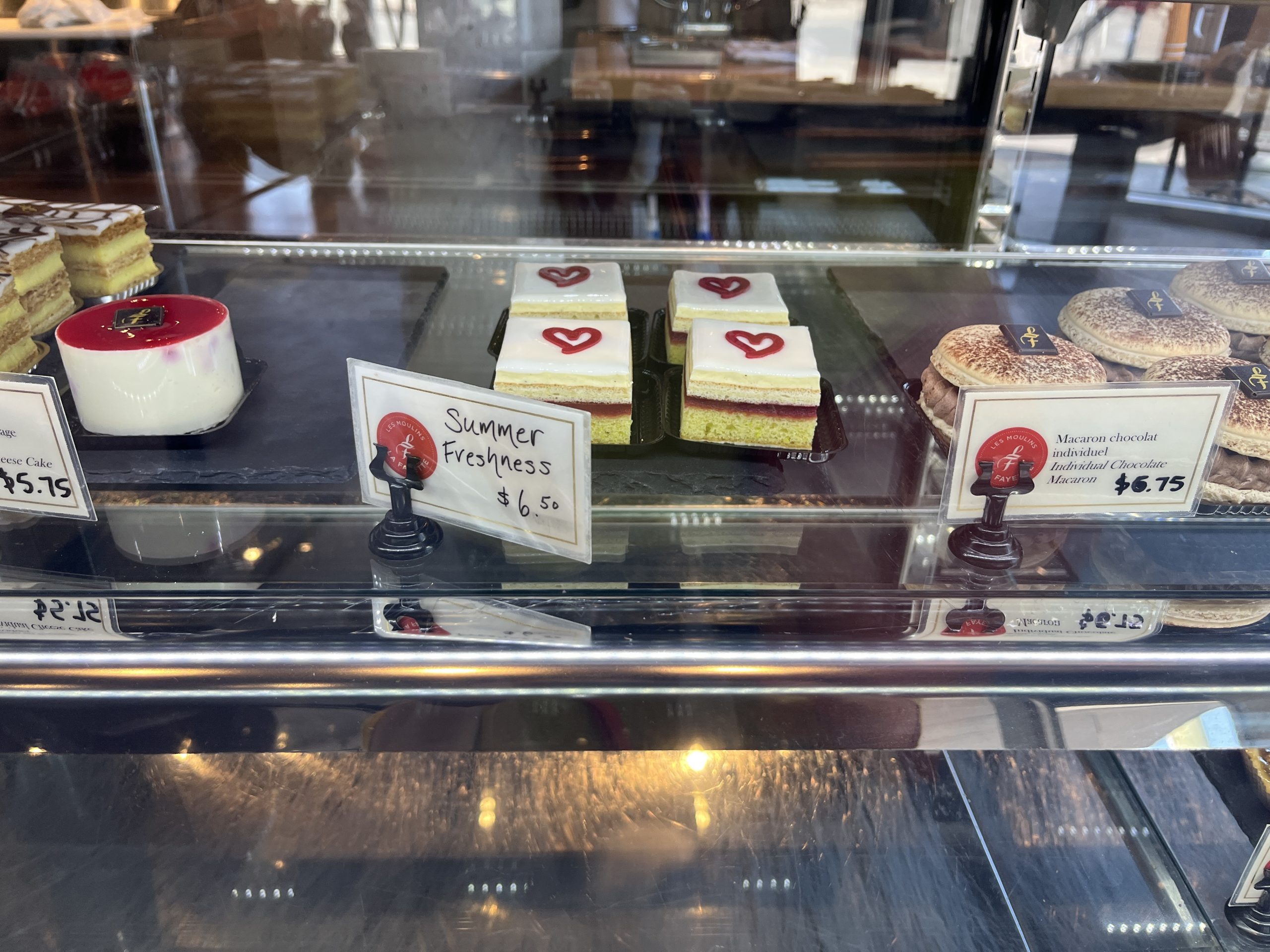 Different pastries sit in a display case. 