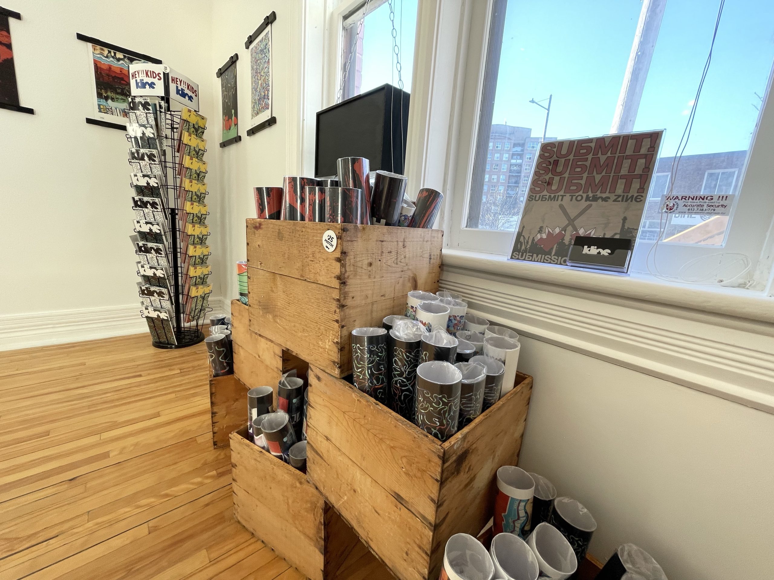 Boxes filled with posters sit stacked on the floor at Urban Art Collective.