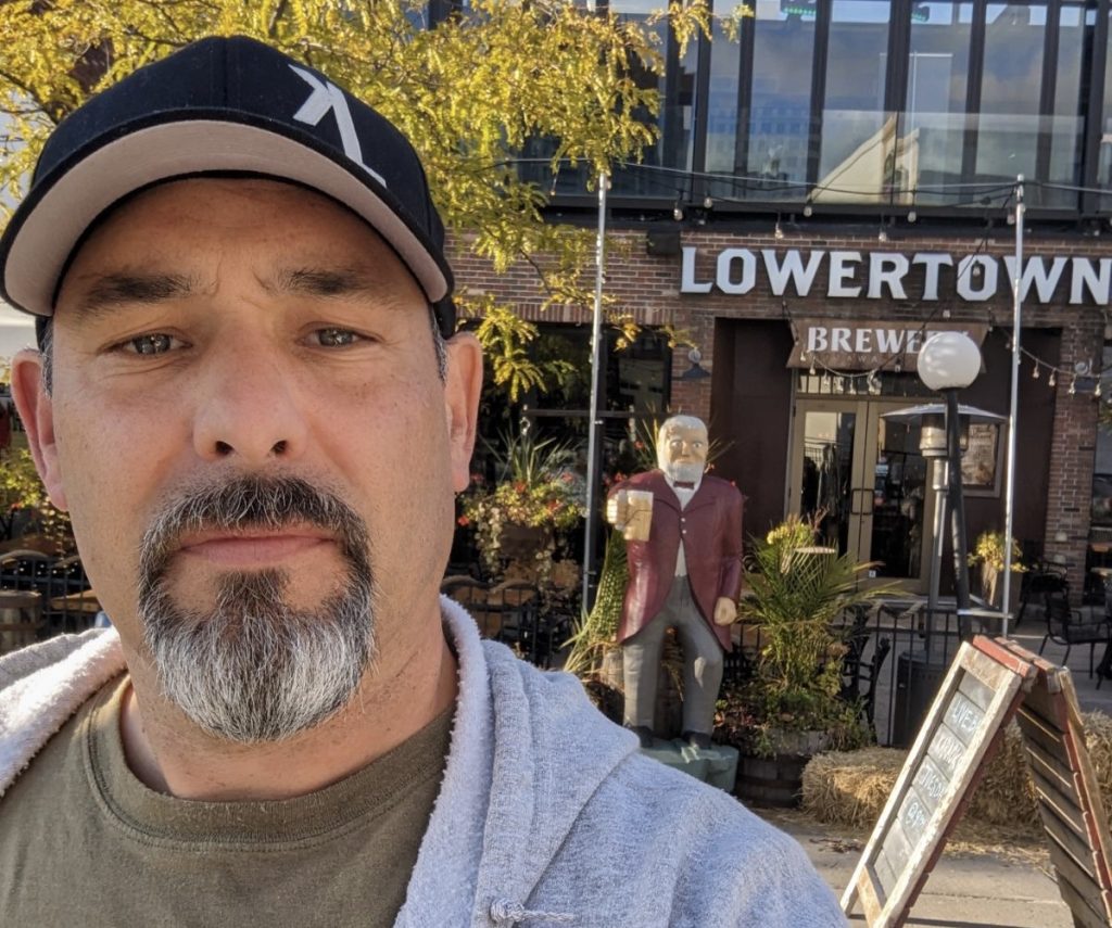 Garet takes a photo outside of Lowertown Brewery 