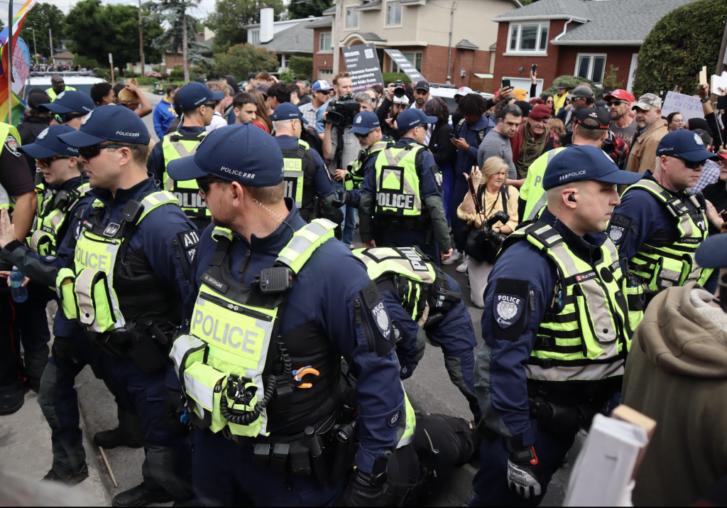 Ottawa Police form in a circle as someone is arrested. 