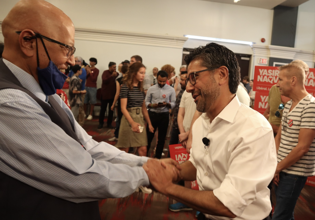 Yasir Naqvi shakes hands with a supporter.