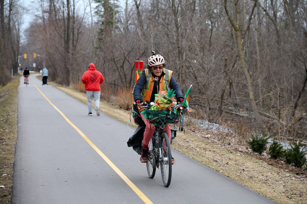 A person rides a funky looking bike on a bike path near Carling. 