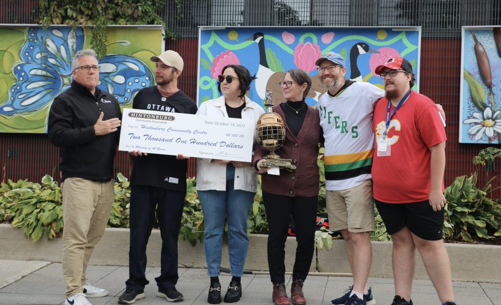 A cheque is presented to the Hintonburg Community Association. 