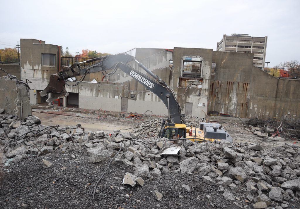 Construction equipment tears down Westboro Station. Only large pieces of concrete are left