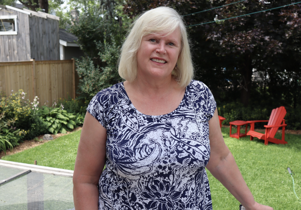 Paula poses for a photo in her backyard. 