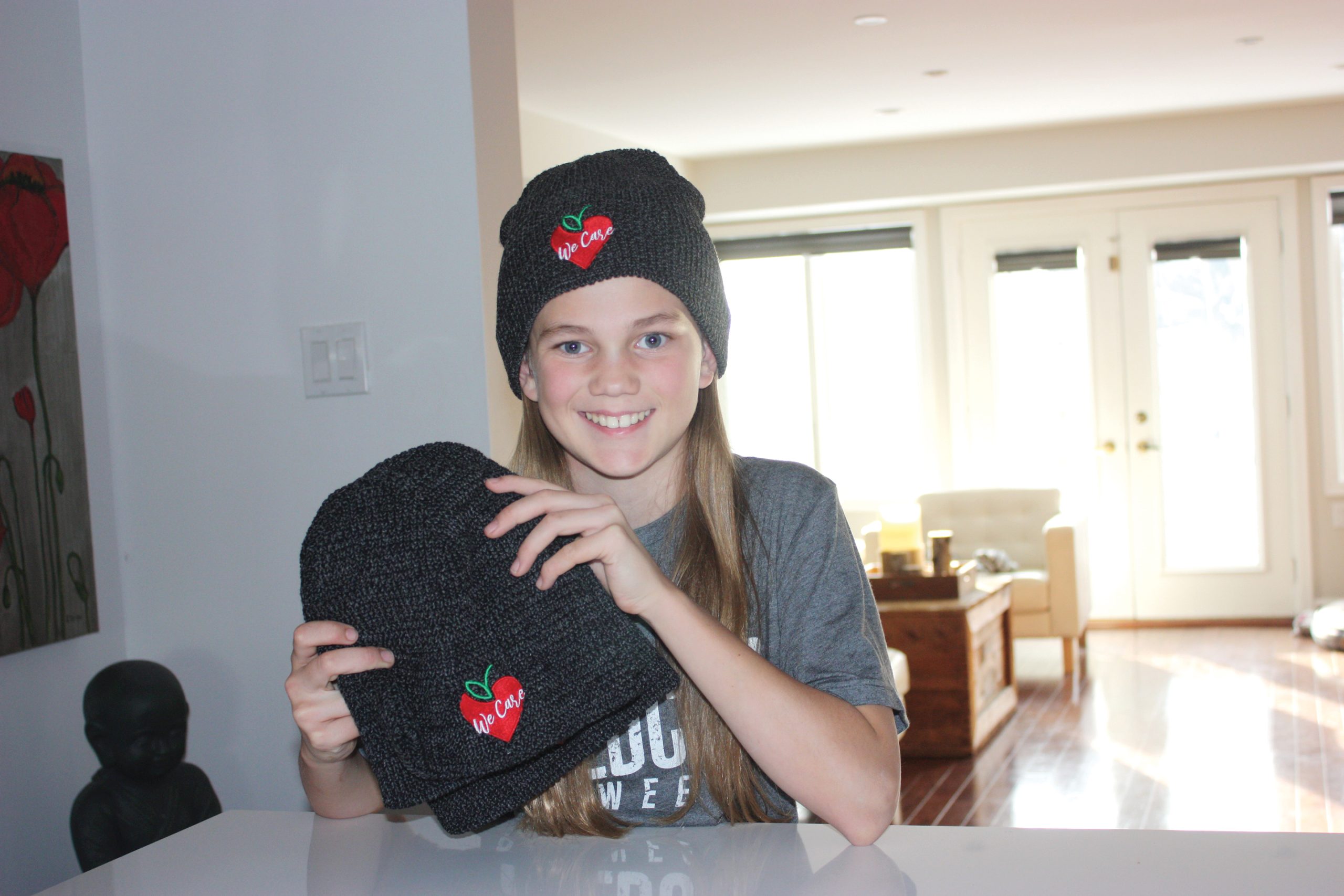 Kylie Hollingsworth, 11, shows off the toques she is selling to raise funds for the Parkdale Food Centre.